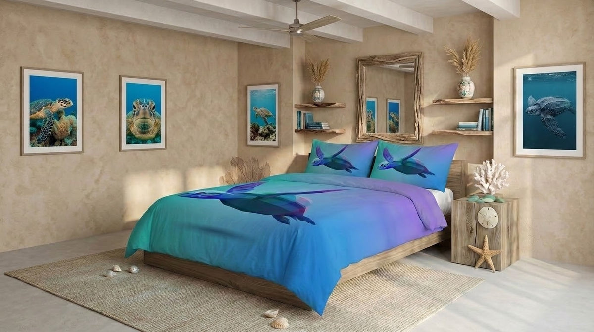 A bed dressed in a blue-to-purple gradient quilt cover with matching pillowcases featuring a low poly print, styled in a beach-themed bedroom with framed ocean artwork on beige walls.