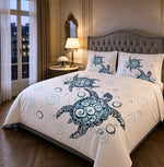 A bed dressed in a white bedding set featuring a large blue sea turtle and matching pillowcases, styled in a classic Parisian-style bedroom with wood floors, a window, and a bedside table in left side angle.