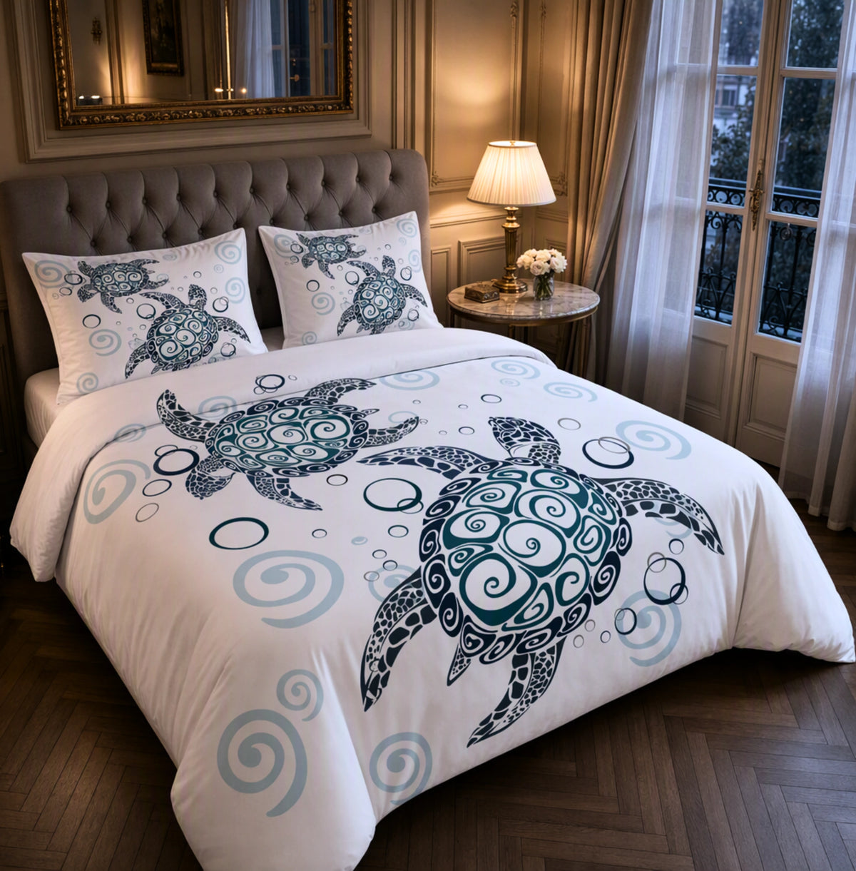 A bed dressed in a white comforter set with a large teal and navy turtle print and matching pillowcases, styled in a warm, elegant bedroom with wood floors, a tufted headboard, and a window with curtains.