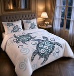 A bed dressed in a white comforter set with a large teal and navy turtle print and matching pillowcases, styled in a warm, elegant bedroom with wood floors, a tufted headboard, and a window with curtains.